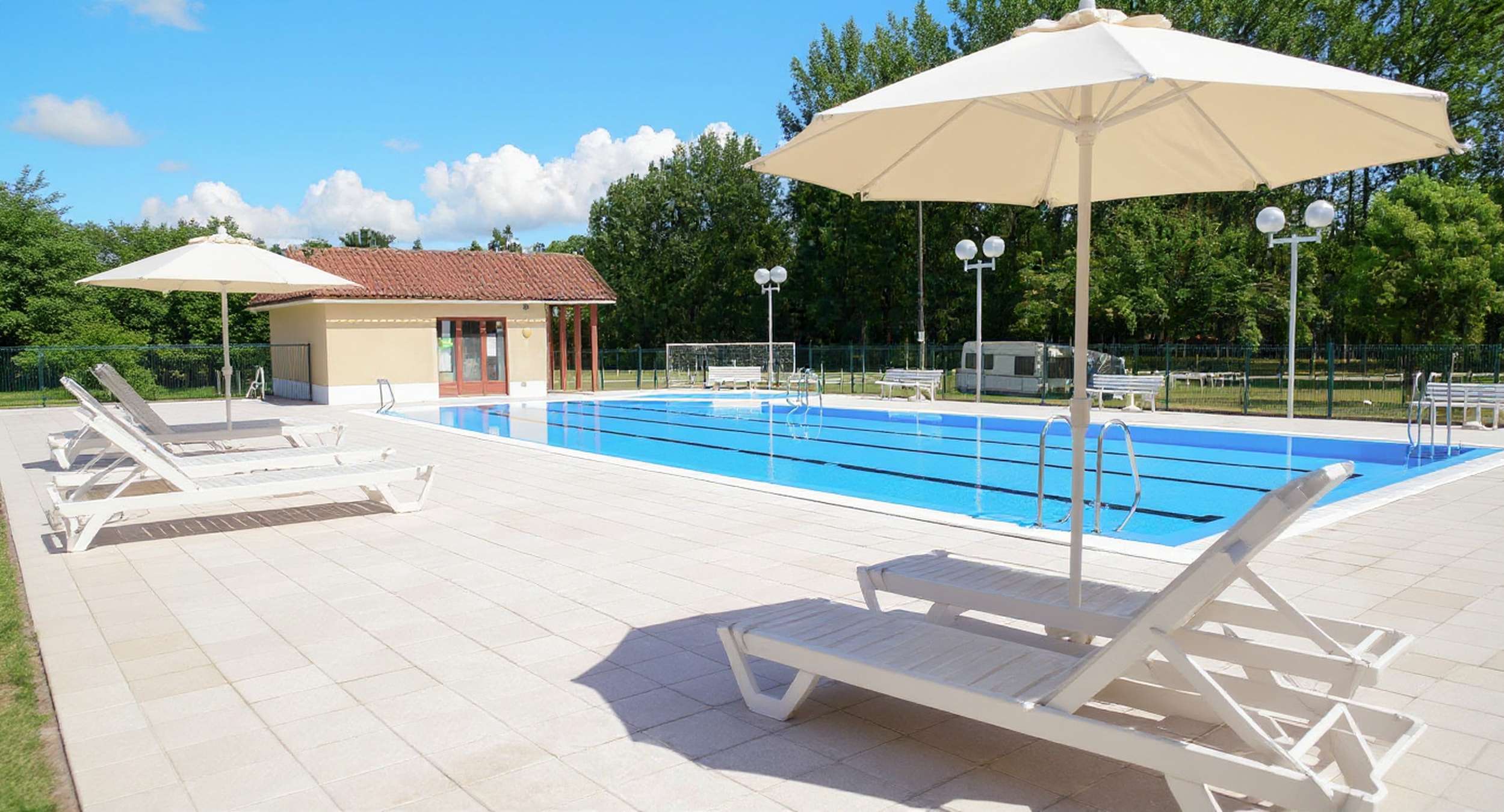 transats et parasol au bord de la piscine